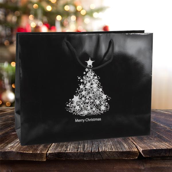 Large Merry Christmas paper carrier bags from stock at MIDPAC Packaging. Black gloss laminated paper carrier bags with a silver Merry Christmas design